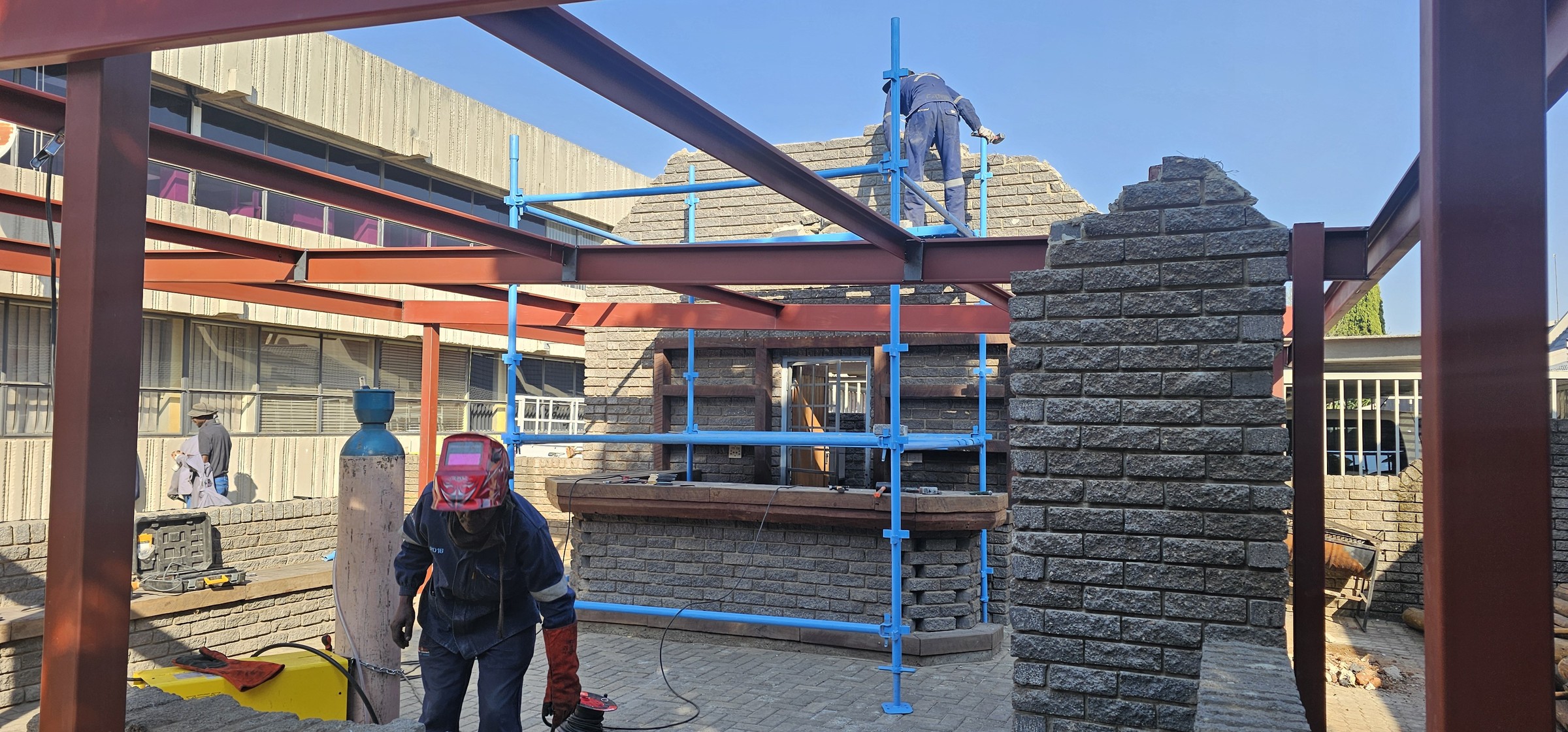 Atlas construction team building steel framing and masonry on site